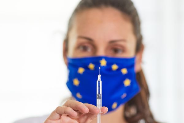 Symbolic - Researcher and glass vaccine vials