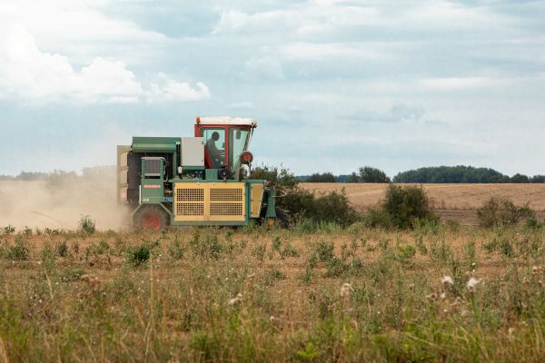 Eine landwirtschaftliche Maschine, die nach der Ernte Strohballen auf einem Feld formt