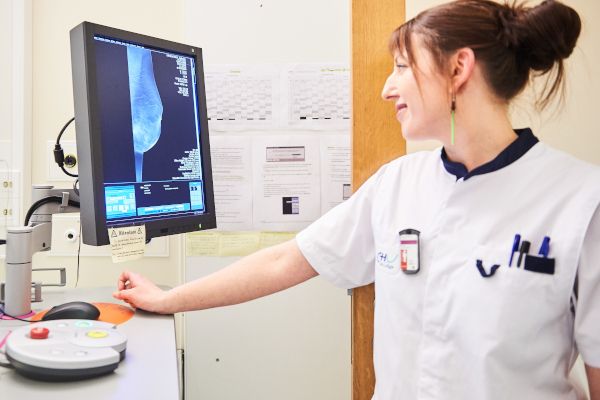 Eine Krankenschwester blickt auf einen Computerbildschirm