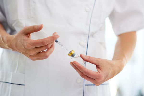 Symbolic - Researcher and glass vaccine vials
