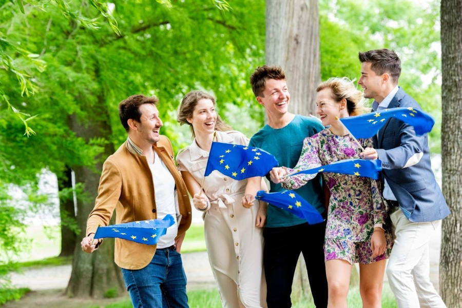 5 junge Menschen halten EU-Flaggen