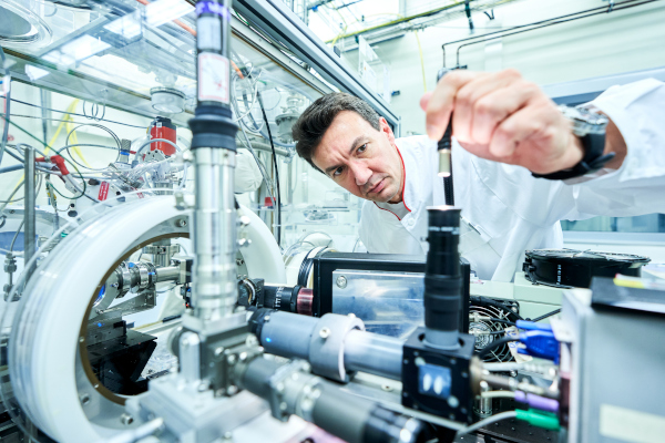 A researcher aligns the laser and optical diagnostic instrumentation before laser-heating a sample of nuclear material